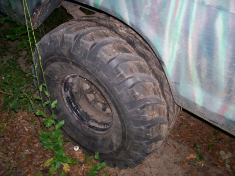 1976 Ford F-100 - This photo shows a close-up of a large off-road tire mounted on a vehicle with camouflage paint.