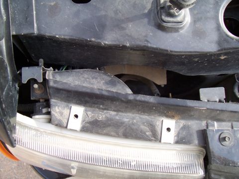 2003 Ford Ranger - Mounting bracket for a vehicle's headlight assembly is visible in this close-up shot.