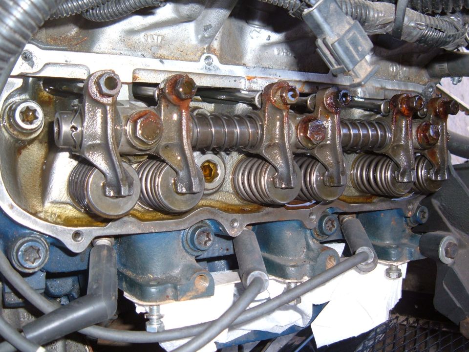 Engine valve train with rocker arms and springs