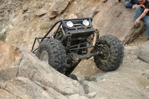 1992 Toyota Tacoma - A custom-built off-road buggy navigates a rocky incline with two people watching from above.