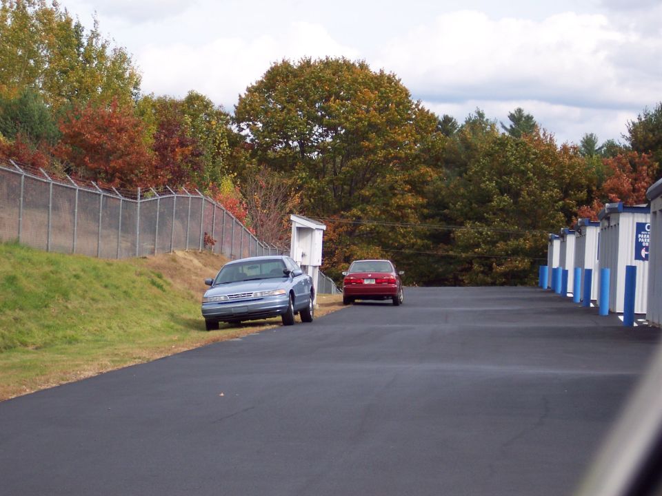 2001 Ford Crown Victoria parked on asphalt with a red car behind it