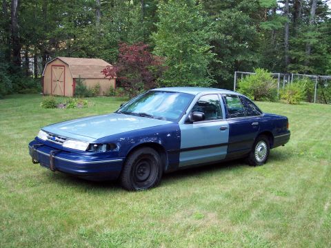 2001 Ford Crown Victoria - This 2001 Ford Crown Victoria has two-tone paint and is parked in a grassy yard.