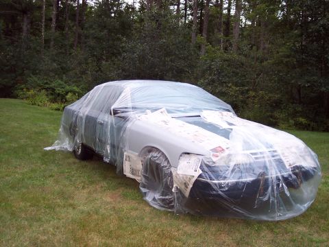 2001 Ford Crown Victoria - A 2001 Ford Crown Victoria is covered in plastic sheeting, preparing for paintwork.