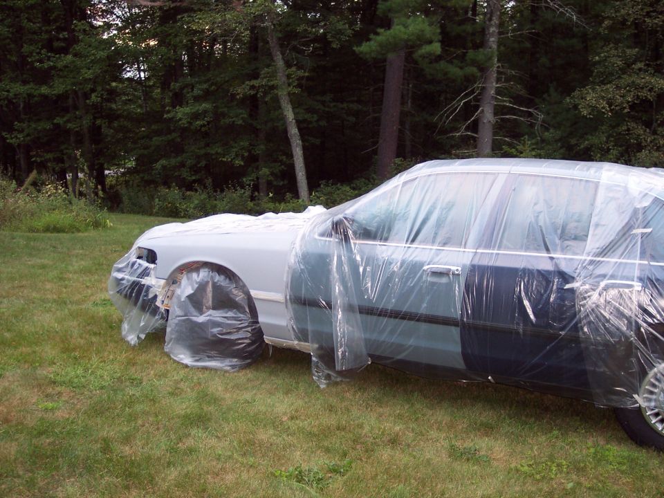 2001 Ford Crown Victoria covered in plastic sheeting, 3q-front view