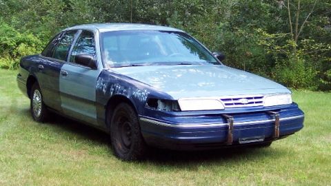 2001 Ford Crown Victoria - This 2001 Ford Crown Victoria has a two-tone paint job with a missing headlight and mismatched front fenders.