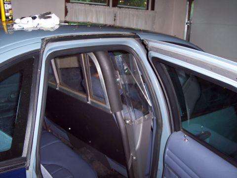 2001 Ford Crown Victoria - The interior of a police car is shown, a partition between the front and rear seats.