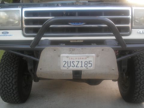 1990 Ford Bronco - This Ford truck features a chrome grille and a brush guard over its front bumper.