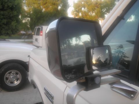 1990 Ford Bronco - A close-up view of a truck's side mirror assembly, with a secondary mirror and camera mount attached.