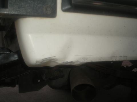 1990 Ford Bronco - Close-up view of the rear bumper and exhaust system of a vehicle.