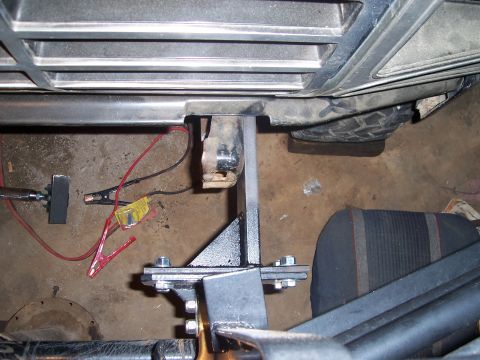1983 Ford Bronco - Custom brushguard mounting hardware is attached to the front of a vehicle, near the grille and a tire.
