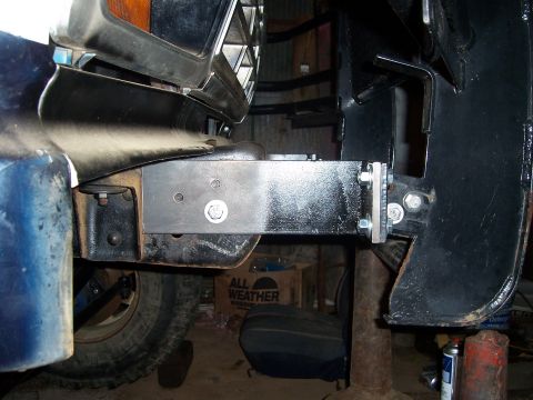 1983 Ford Bronco - Close-up view of a custom brushguard and bumper mounting bracket on a vehicle.