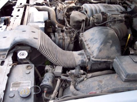 1990 Ford Crown Victoria LTD - Close-up view of a car's engine bay, showing the air intake system and engine components.