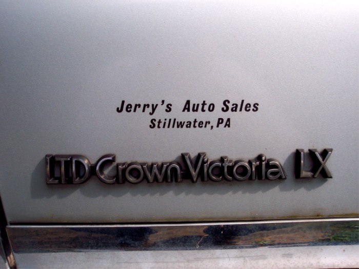 LTD Crown Victoria LX badge on light blue car
