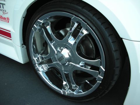 1998 Ford Crown Victoria - Close-up of chrome American Racing wheels on a white vehicle red racing stripes.