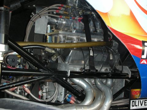 1998 Ford Crown Victoria - Close-up view of a modified engine bay, showing a supercharger and exhaust system.