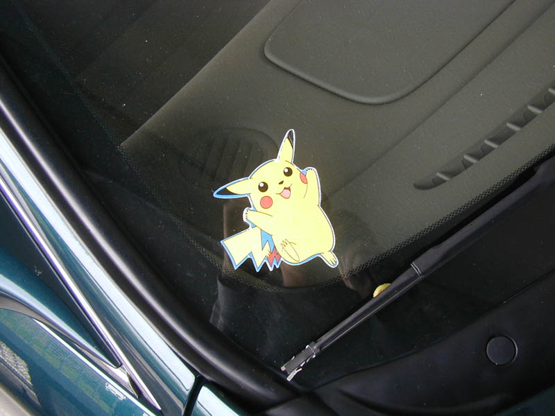 Pikachu decal on the cowl below a car windshield with wiper visible