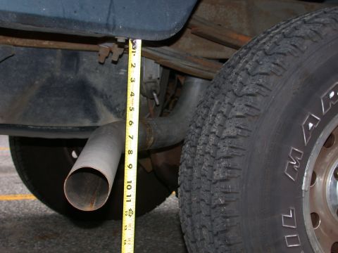 1995 Ford Bronco - Measuring exhaust pipe clearance with a tape measure.
