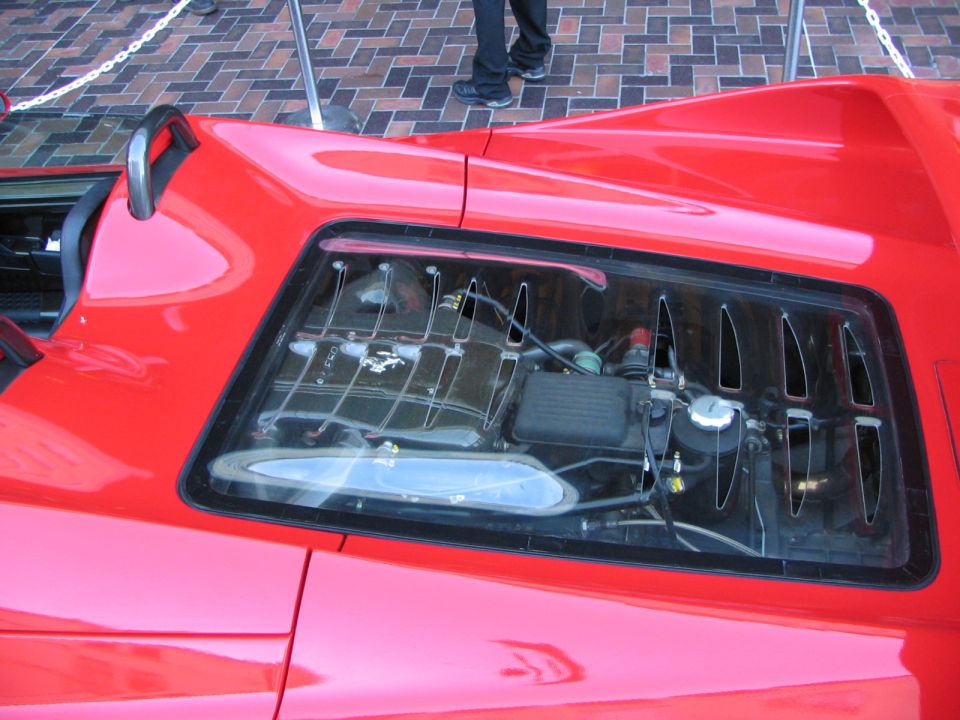Red 1986 Pontiac Fiero engine compartment with visible V6 engine