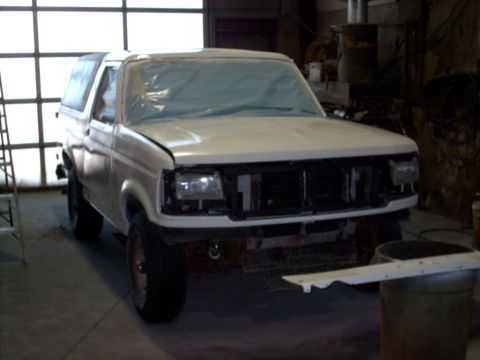 1990 Ford Bronco - This SUV is undergoing repairs or modifications in a workshop setting.