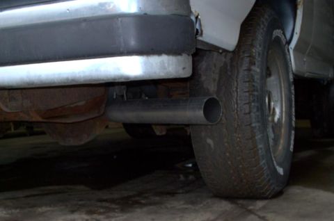 1990 Ford Bronco - Close-up view of a vehicle's exhaust pipe and rear tire.