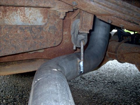 1990 Ford Bronco - Underbody view shows a section of exhaust pipe attached to a heavily rusted frame.