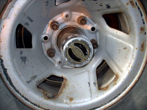 1990 Ford Bronco - Warn locking hub is visible on this wheel, which is part of a vehicle.