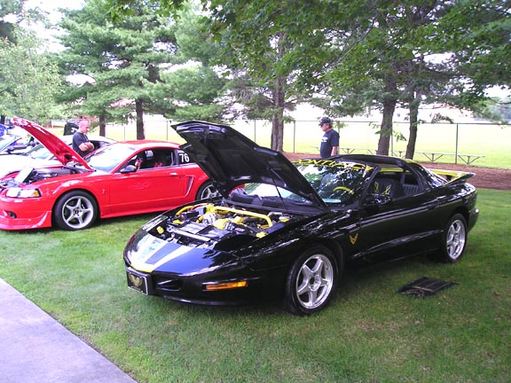 Black 1994 Pontiac Firebird Trans Am with hood open, yellow accents