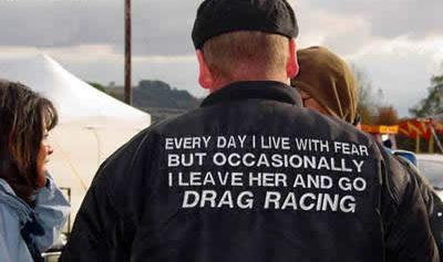 2000 Ford Crown Victoria - A man's jacket displays a humorous message about his passion for drag racing, suggesting a break from daily life for the thrill of the trac…