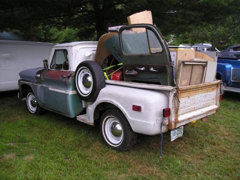 1984 Pontiac Fiero - This 1966 Chevrolet C10 pickup truck is loaded with various parts, including a spare tire and a truck door.