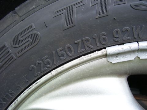 1994 Ford Probe - Close-up of a tire and wheel assembly, showing tire size and wheel weights.
