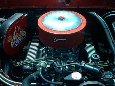 1978 Ford Bronco - The engine bay features a prominent air filter and a decorative fender skirt with a Ford logo and flame graphics.