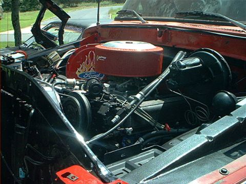 1978 Ford Bronco - Custom engine bay a red Ford air cleaner with flame decals and a prominent brake booster assembly.