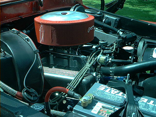 Engine bay showing air cleaner, battery, and wiring