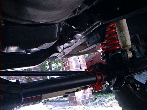 1978 Ford Bronco - A close-up view of the undercarriage reveals the vehicle's suspension system components.