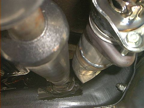 1978 Ford Bronco - Underside view of exhaust system components, including pipes and a U-joint.