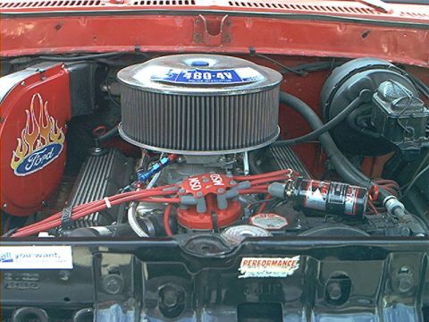 1978 Ford Bronco - Close-up of a modified Ford V8 engine, an aftermarket air intake and ignition components.