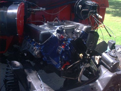 1978 Ford Bronco - Close-up of a V8 engine, showing blue valve covers and a large fan.