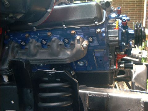 1978 Ford Bronco - The engine block is painted blue with silver exhaust manifolds and spark plug wires attached.