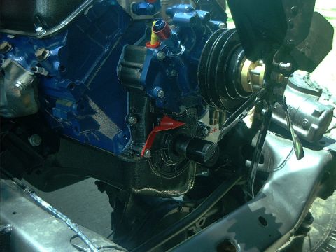 1978 Ford Bronco - Close-up view of a blue engine block, fan, and pulleys, likely during a build or restoration.