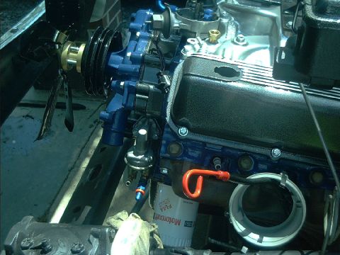1978 Ford Bronco - Close-up view of an engine bay, highlighting the blue painted engine block and black valve cover, with a visible oil filter.
