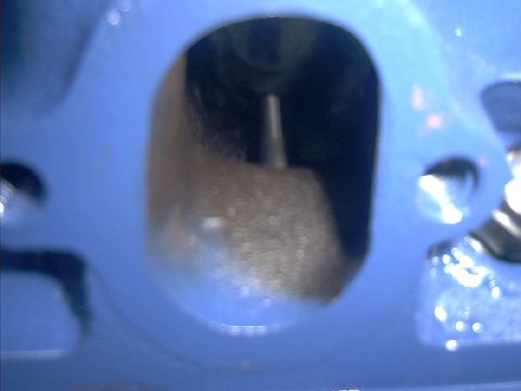 1978 Ford Bronco - A view into an engine cylinder, showing a valve stem protruding into the chamber.