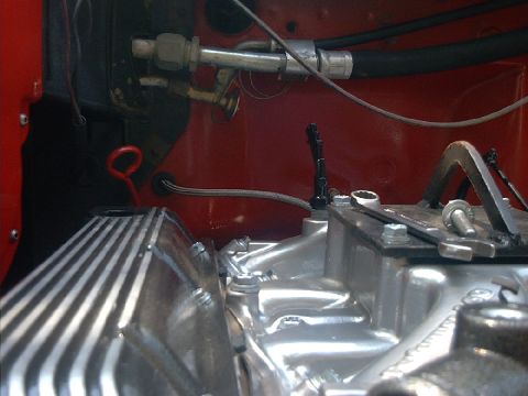 1978 Ford Bronco - A view of engine components including the valve cover and intake manifold, with visible hoses and wiring.