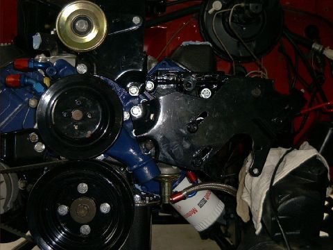 1978 Ford Bronco - Close-up view of engine components, including pulleys and an oil filter.