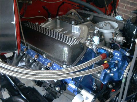 1978 Ford Bronco - This engine features aftermarket valve covers and a blue painted oil pan, suggesting custom modifications.