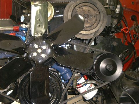 1978 Ford Bronco - The engine bay features a large fan, multiple belts, and an oil filter with visible markings.