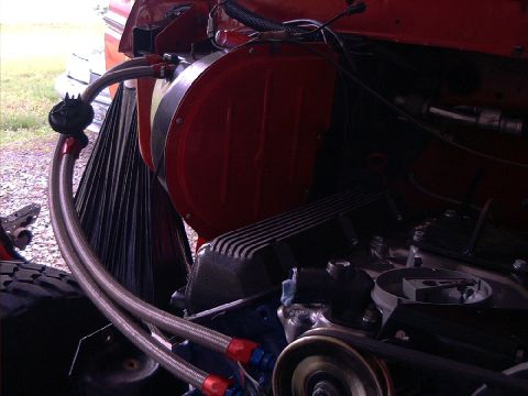 1978 Ford Bronco - Close-up view of an engine bay, showing various mechanical components and red accents.