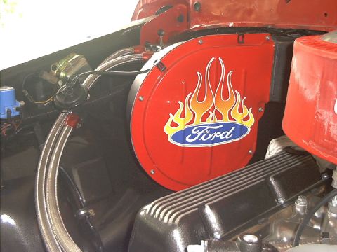 1978 Ford Bronco - The engine bay features a red fan housing adorned with flame graphics and the Ford logo.