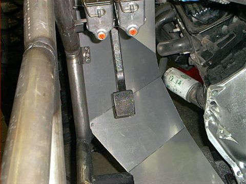 1978 Ford Bronco - This image shows the interior of a vehicle, focusing on the pedals and engine bay components.