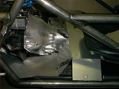 1978 Ford Bronco - Custom metal fabrication and roll cage tubing are visible in this close-up of a vehicle's interior and engine bay.