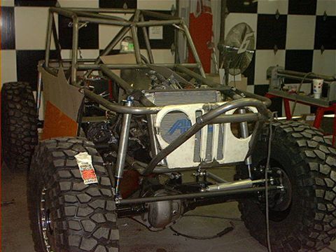 1978 Ford Bronco - This custom off-road vehicle features a prominent roll cage and oversized tires, with a tag visible on the front tire.